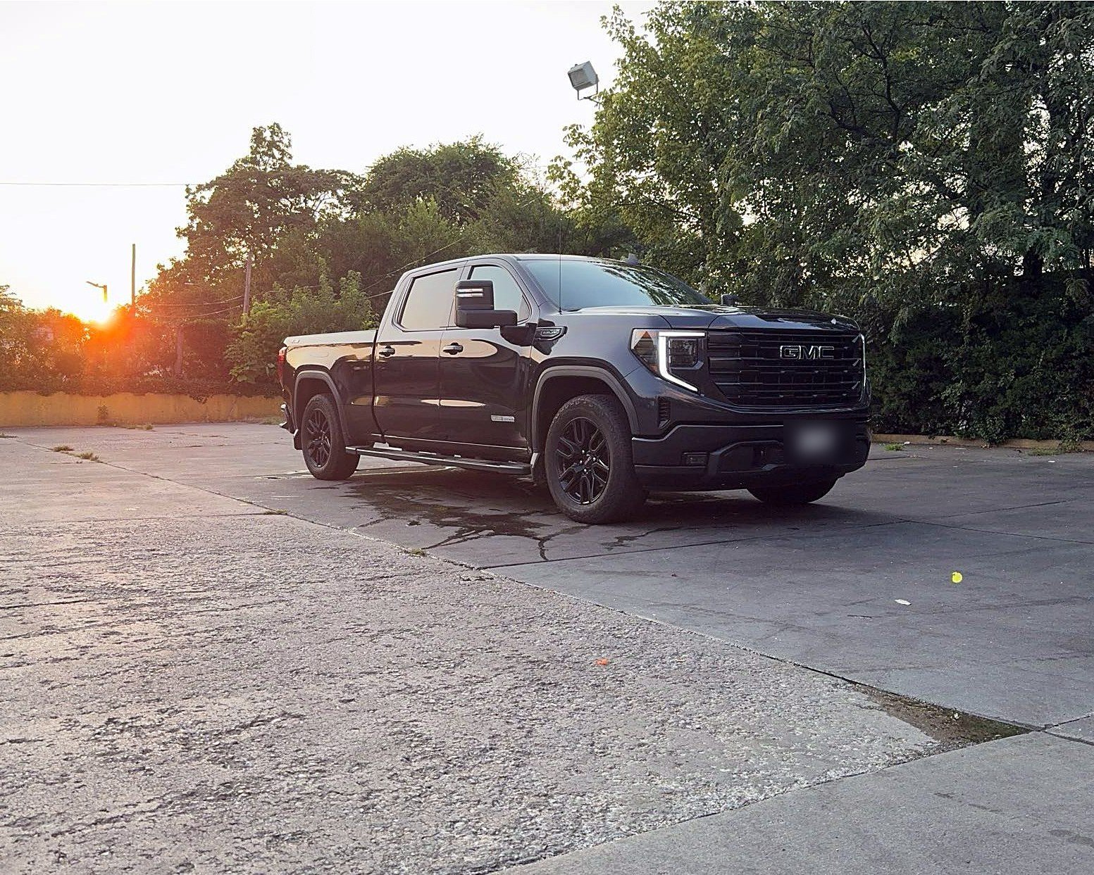 WTM work truck, a black GMC pickup, at sunset
