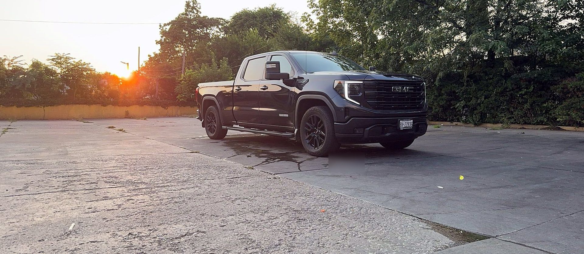 WTM work truck, a black GMC pickup, at sunset