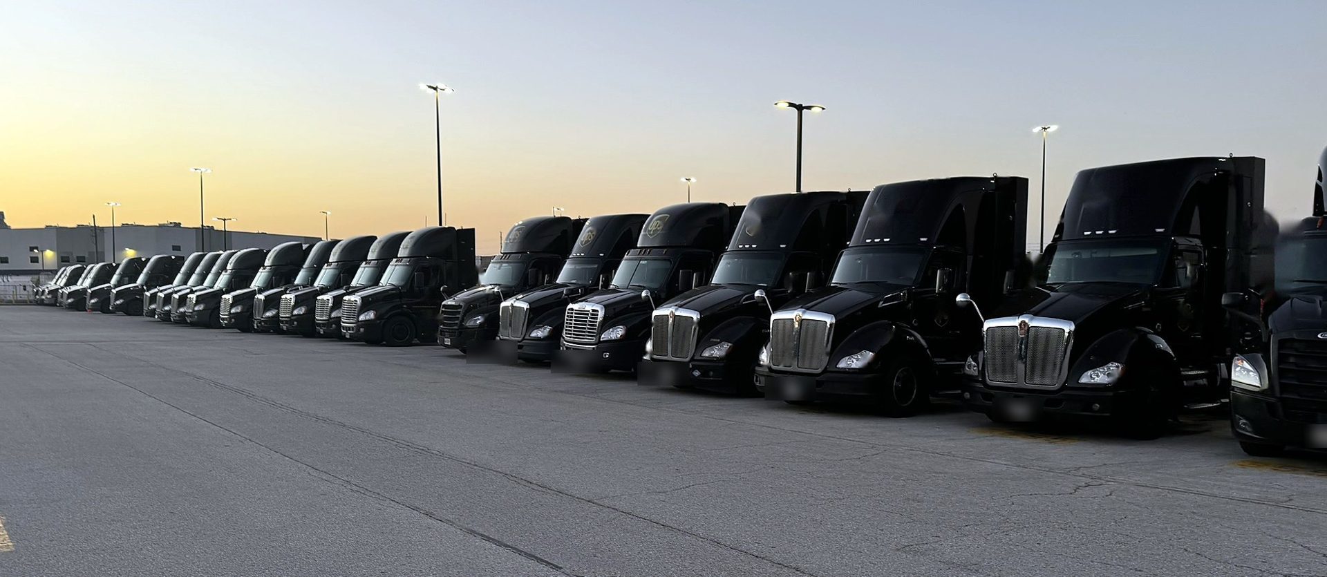 Row of highway tractors at sunset