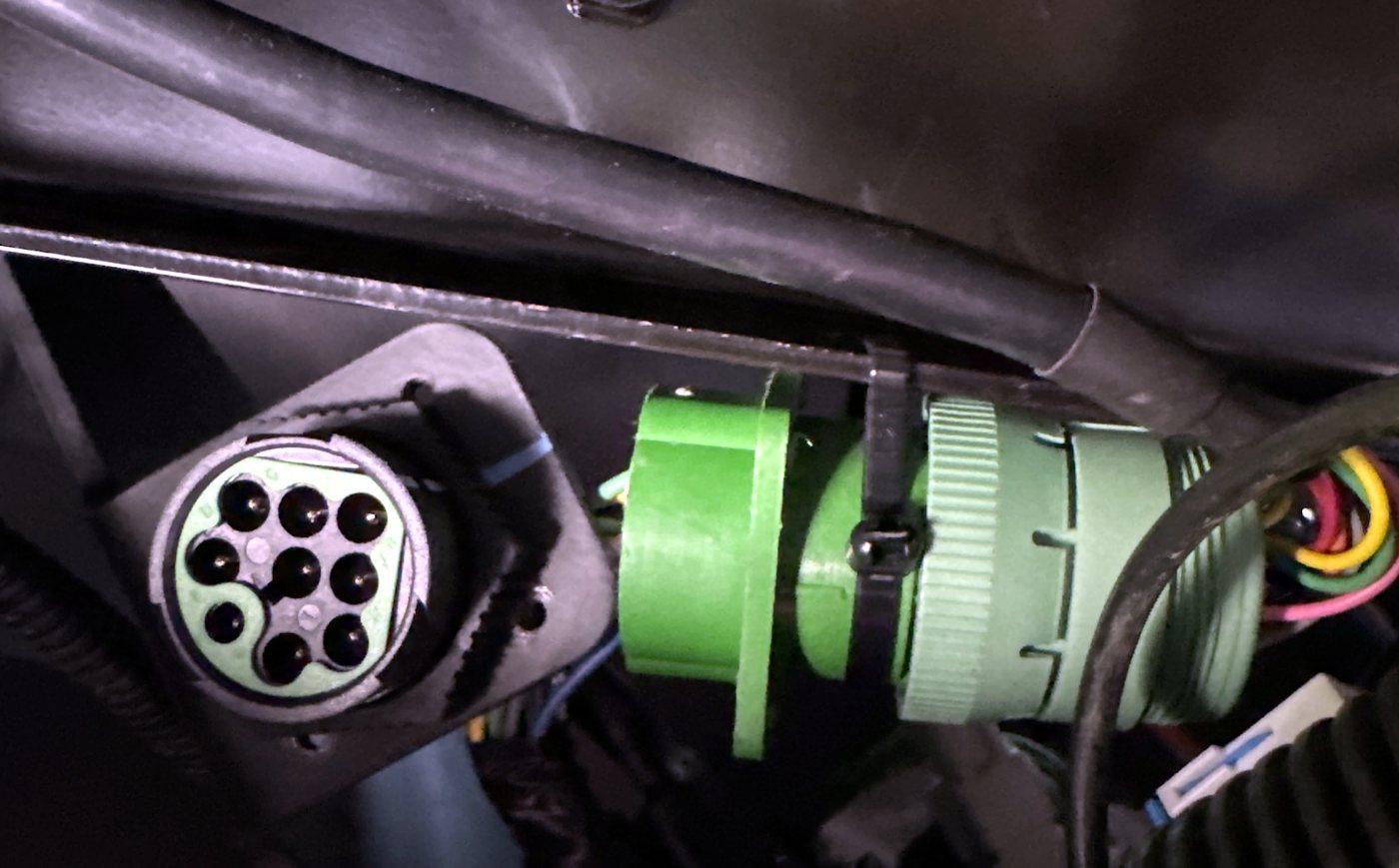 Nine-pin diagnostic connector bracket-mounted with the Y-cable zip-tied