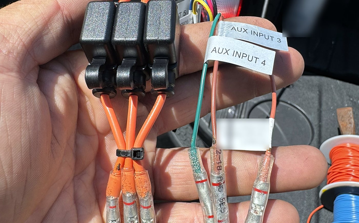 Hand-built fused harness with heat-shrink solder splices and labelled auxiliary inputs