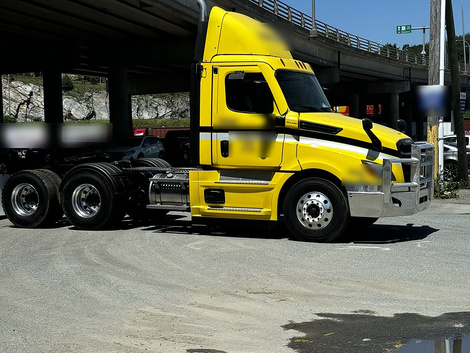 Yellow highway tractor in a truck yard