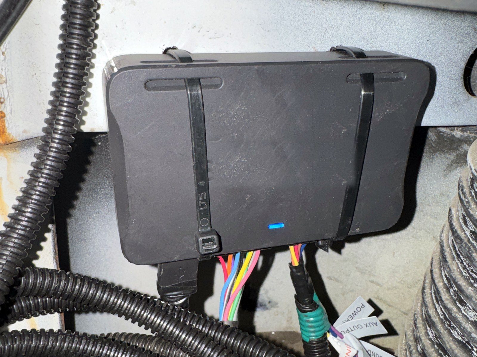 Telematics gateway strapped in place with loomed harness