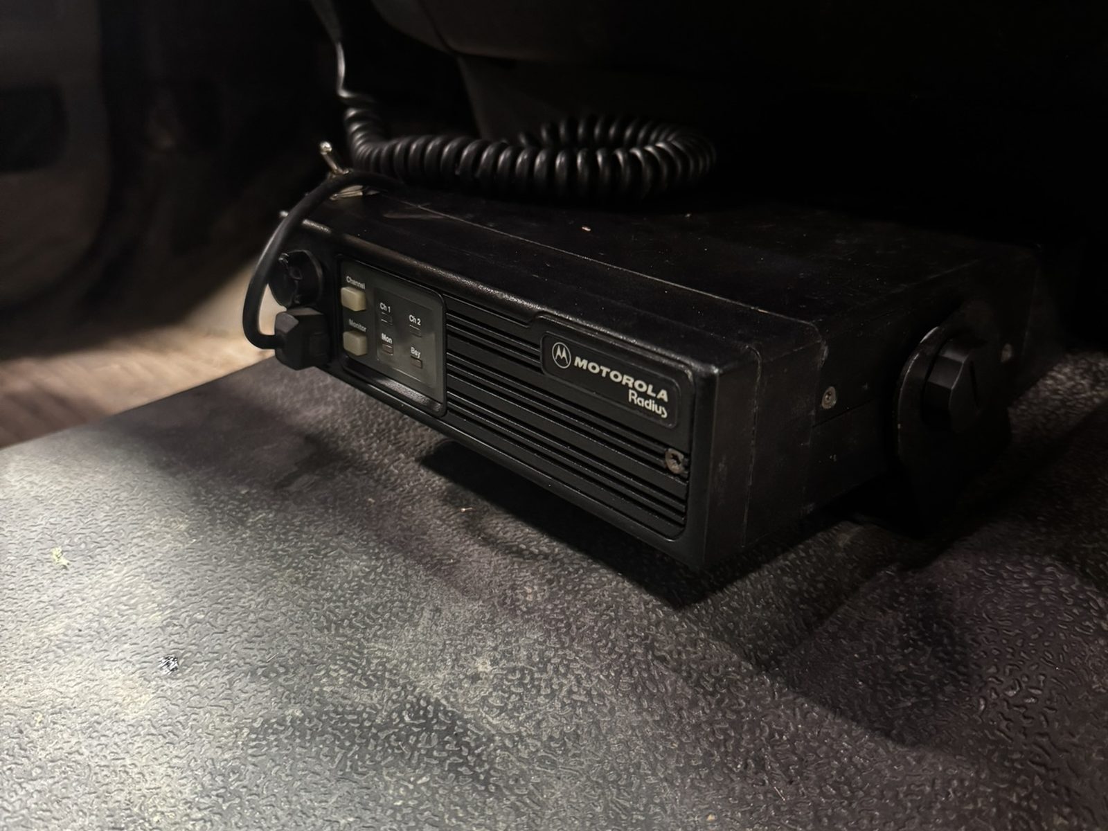 Motorola mobile radio mounted under the dash of a pickup